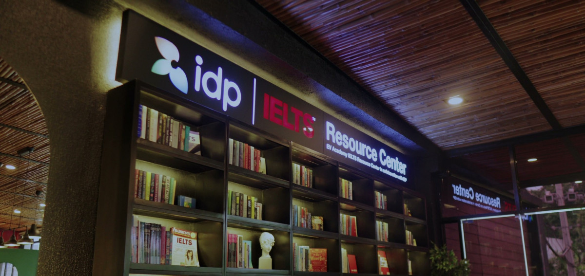 宿霧 EV 語言學校 westudy 交誼廳的 idp IELTS Resource Center 招牌,下面是一整排雅思書櫃