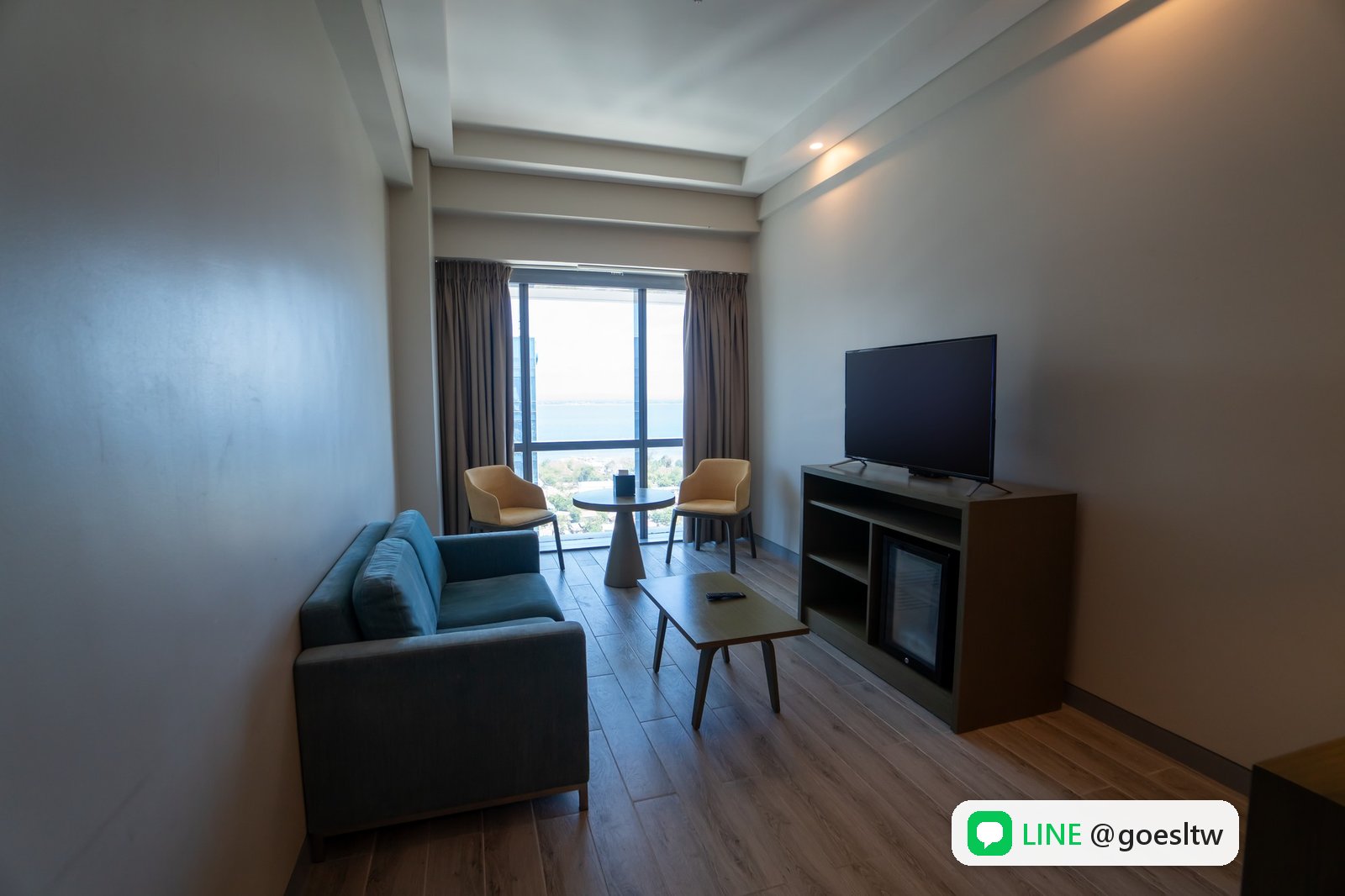QQEnglish Savoy Hotel Junior Suite 套房的客廳,有沙發與電視